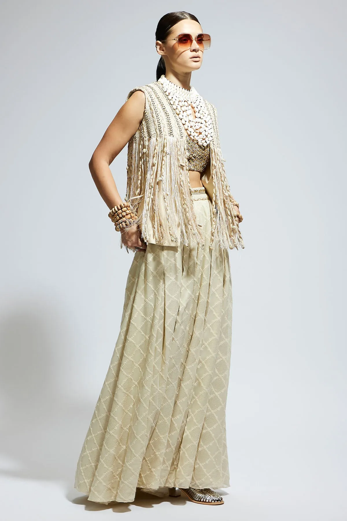 Ivory Threadwork Fringe Jacket Paired Wth Scallop Metallic Bustier and Ivory Aztec Flared Pants