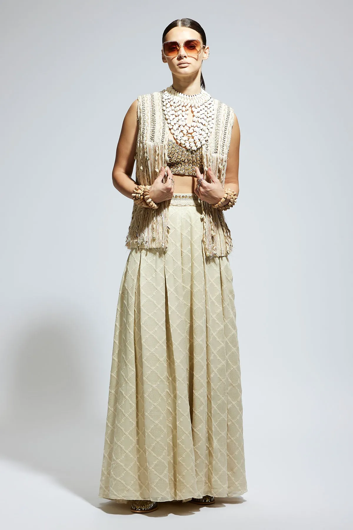 Ivory Threadwork Fringe Jacket Paired Wth Scallop Metallic Bustier and Ivory Aztec Flared Pants