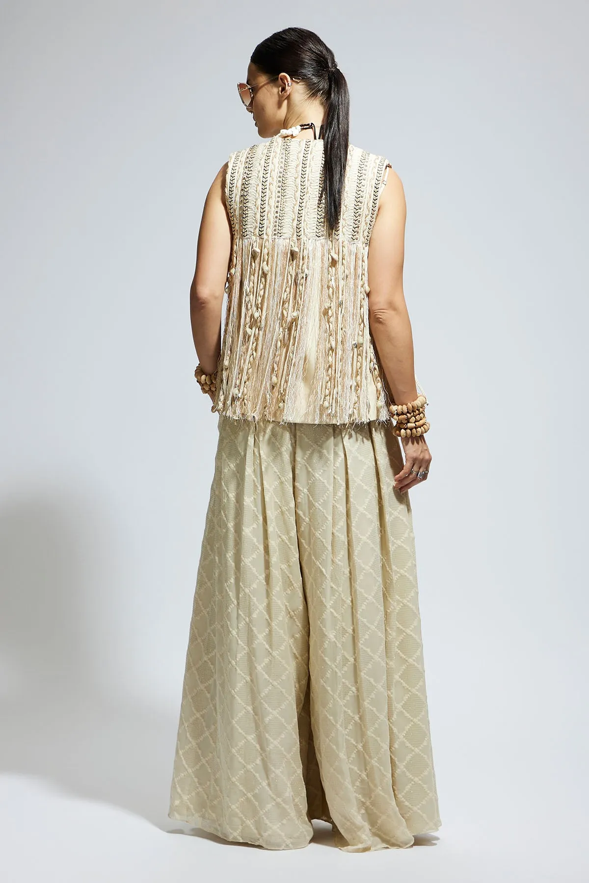 Ivory Threadwork Fringe Jacket Paired Wth Scallop Metallic Bustier and Ivory Aztec Flared Pants