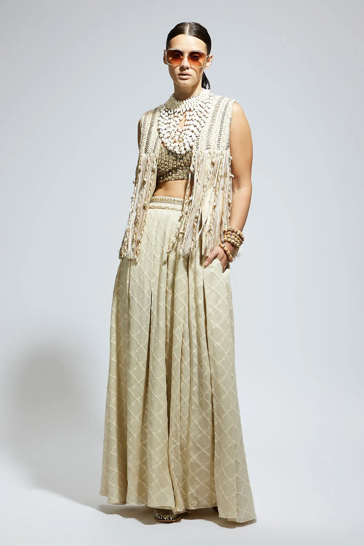 Ivory Threadwork Fringe Jacket Paired Wth Scallop Metallic Bustier and Ivory Aztec Flared Pants